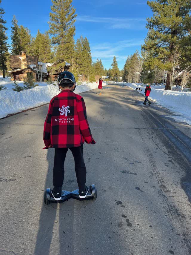 Riding a hoverboard down a snowy street