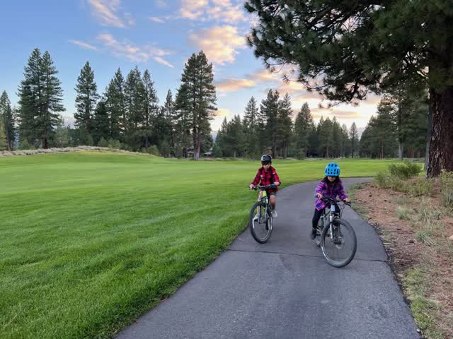 Biking along a path by the golf course