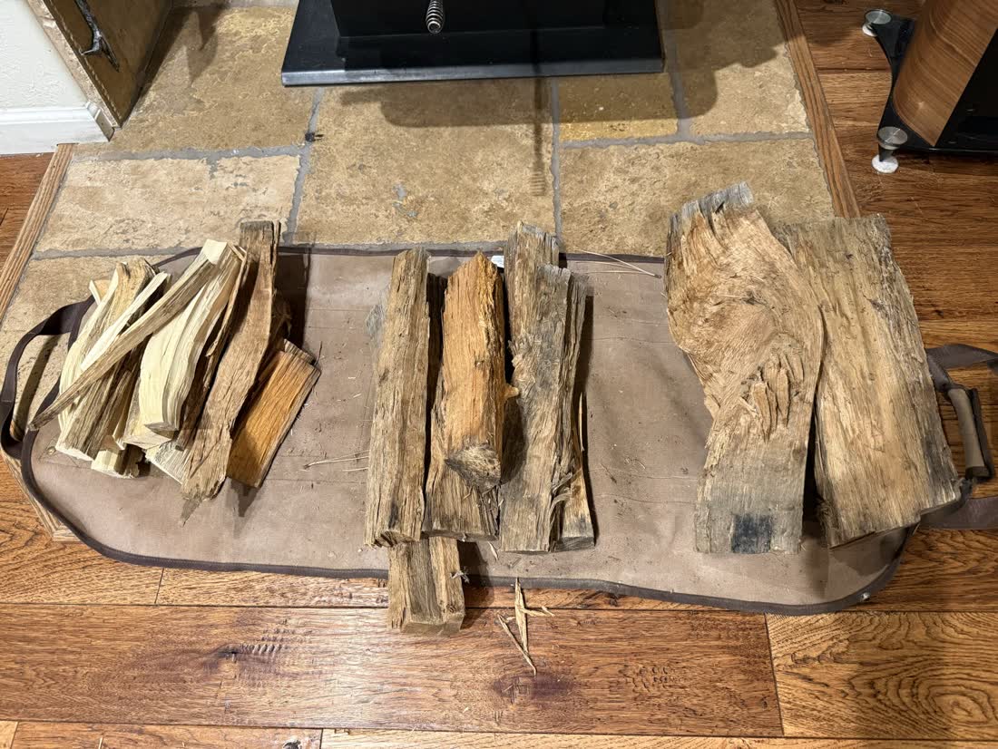 Kindling, pine splits and oak laid out side by side by the stove