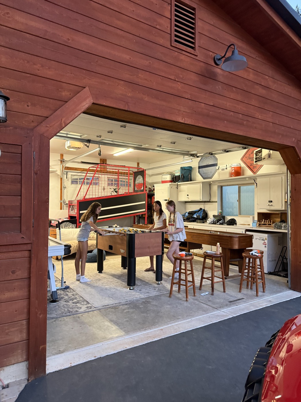 The garage door up, with a foosball game going inside