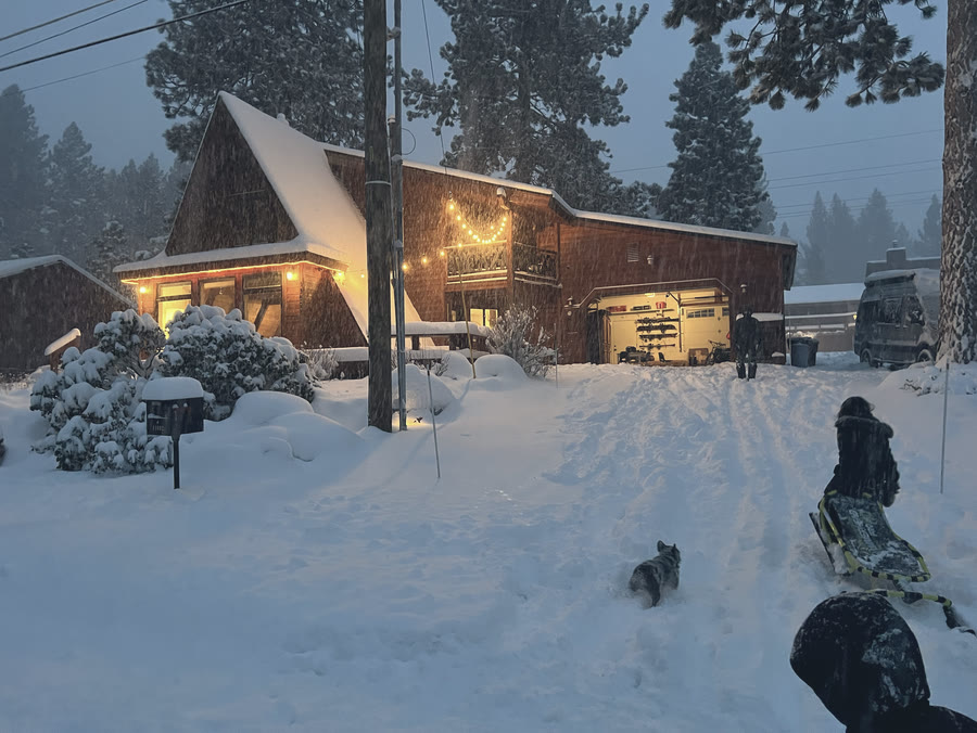 Walking home to the lit cabin at dusk