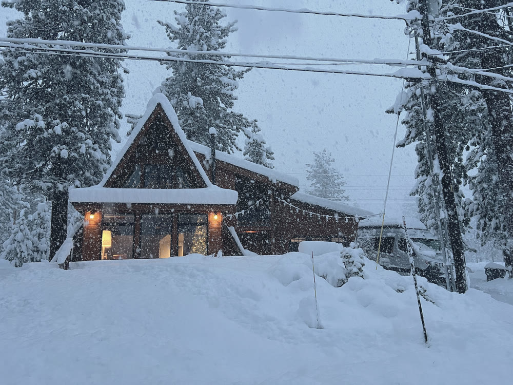The A-frame half buried in falling snow